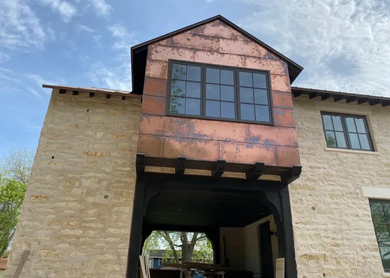 Copper metal panel facade on a stone building for Skylight Installation in Taylorsville